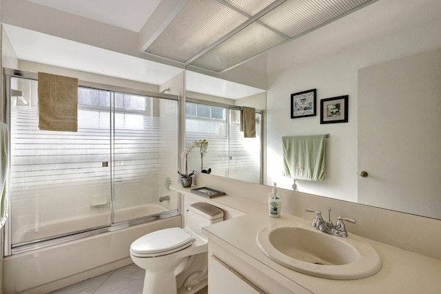 bathroom with combined bath / shower with glass door, toilet, and vanity