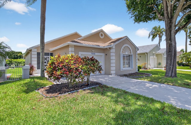 7848 Mansfield Hollow Rd, Delray Beach, FL 33446 - view of front of home featuring an attached garage, stucco siding, and concrete driveway