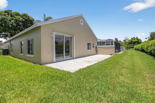 7848 Mansfield Hollow Rd, Delray Beach, FL 33446 - back of house with stucco siding, a patio area, a lawn, and a lanai
