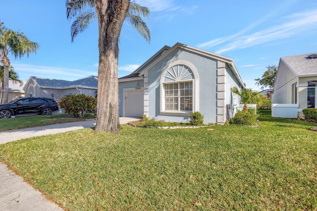 view of front facade featuring a garage, concrete driveway, a front yard, and stucco siding