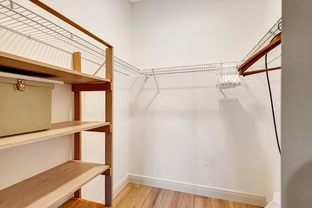 walk in closet featuring light wood-style flooring