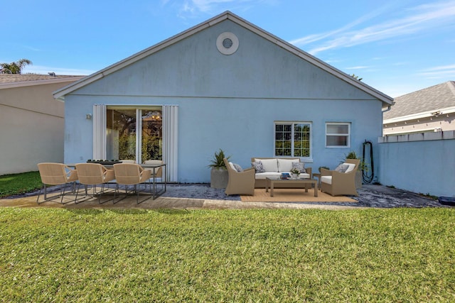rear view of property featuring a patio area, stucco siding, an outdoor hangout area, and a yard