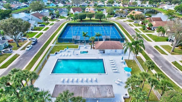 birds eye view of property with a residential view and a water view