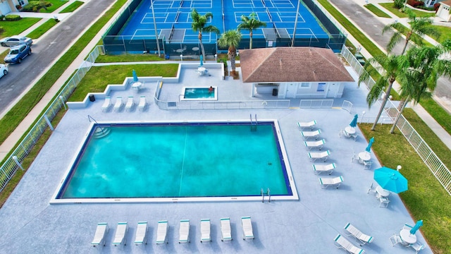 community pool featuring a patio and fence