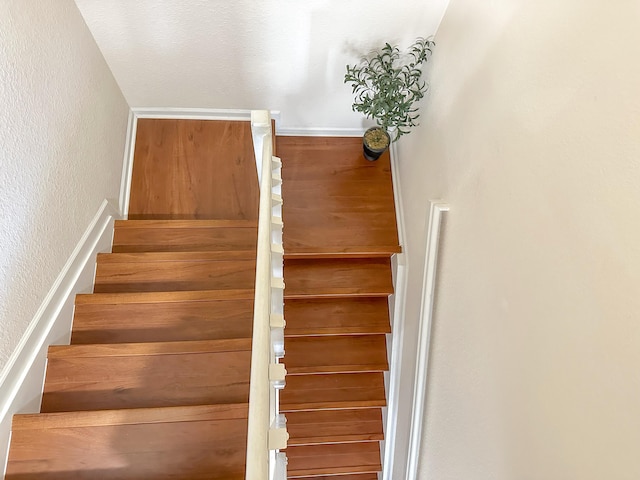 stairs featuring a textured wall