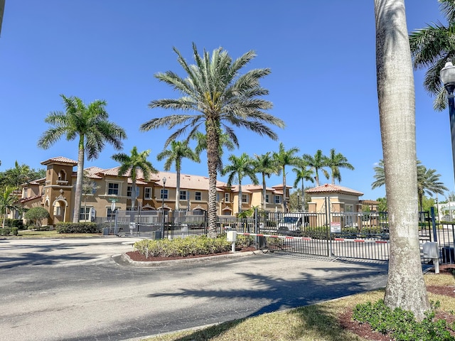 view of building exterior featuring fence and a residential view