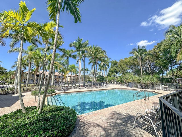 community pool featuring a patio and fence