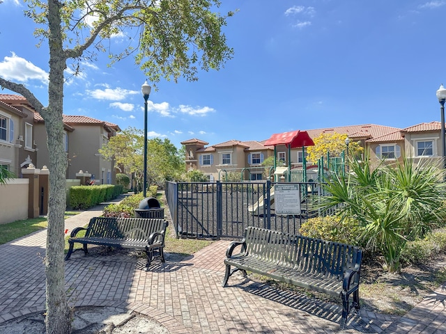 exterior space with playground community, a residential view, and fence