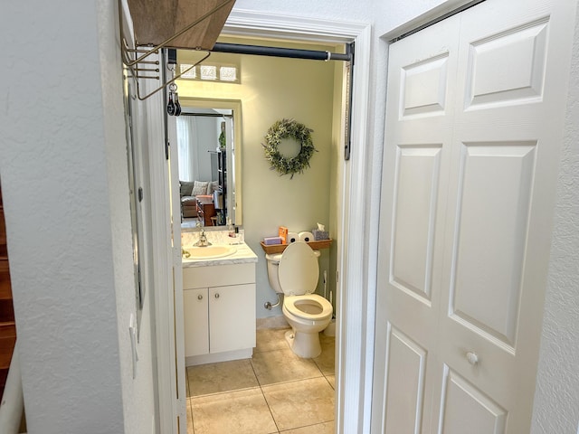 bathroom featuring tile patterned floors, toilet, and vanity