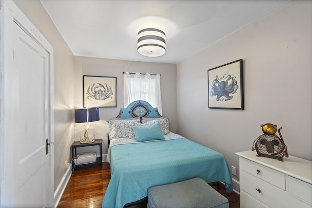 bedroom with wood finished floors and baseboards