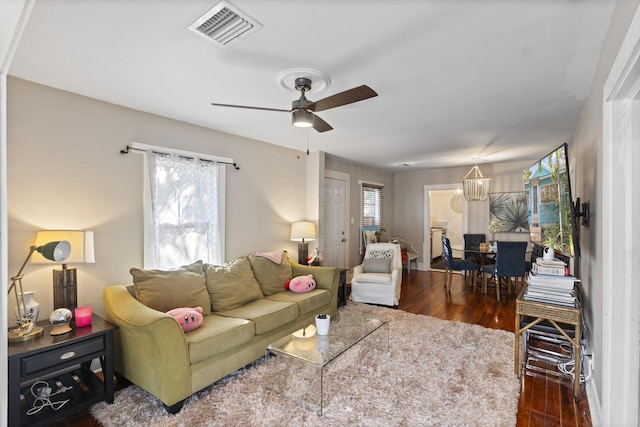 living area featuring visible vents, ceiling fan, and wood finished floors