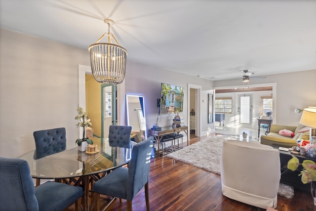 dining room with baseboards, wood-type flooring, and a notable chandelier