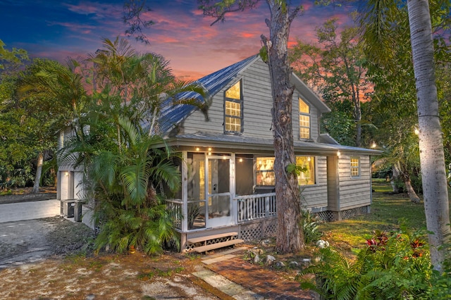 back of house with a sunroom