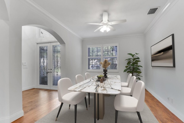 138 Victorian Ln, Jupiter, FL 33458 - dining area featuring visible vents, arched walkways, wood finished floors, and french doors