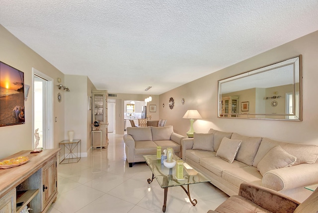 living area featuring light tile patterned floors and a textured ceiling