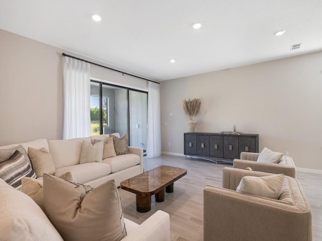 living area featuring recessed lighting, light wood-type flooring, baseboards, and visible vents