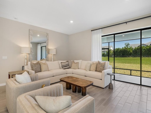 living room with plenty of natural light, recessed lighting, and light wood-type flooring