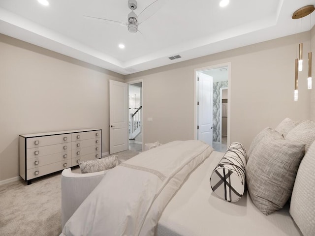 bedroom featuring a ceiling fan, visible vents, recessed lighting, a raised ceiling, and light colored carpet