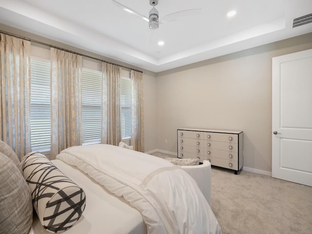 bedroom with visible vents, baseboards, light carpet, recessed lighting, and a raised ceiling