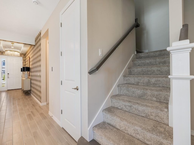 stairway with baseboards and wood finished floors