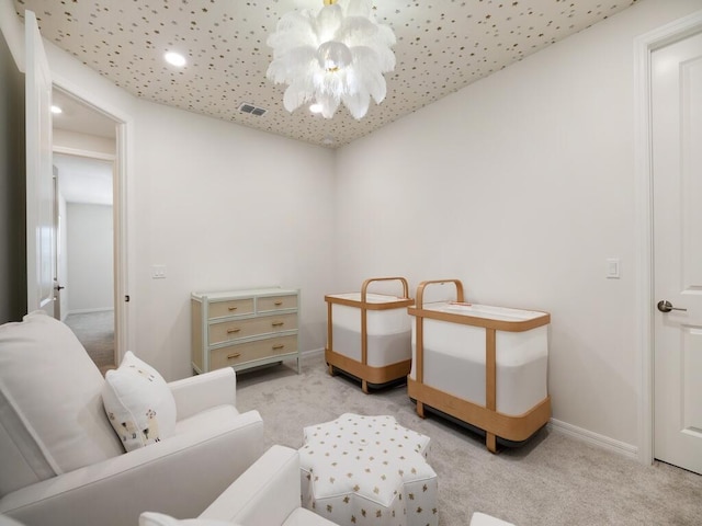 bedroom with visible vents, light carpet, baseboards, and a chandelier