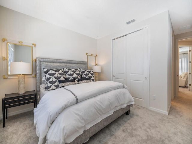 bedroom featuring a closet, baseboards, visible vents, and carpet floors