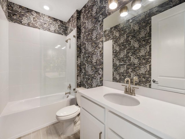 full bathroom with toilet, wallpapered walls, and shower / bathing tub combination