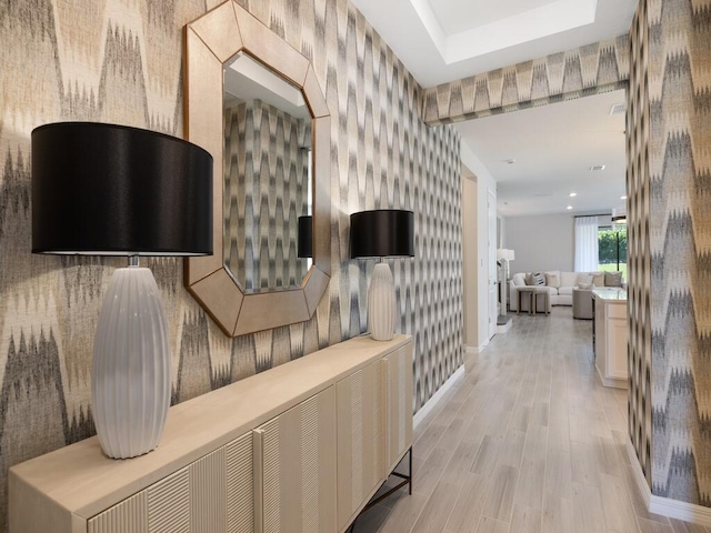 hallway featuring recessed lighting, wallpapered walls, light wood-type flooring, and baseboards