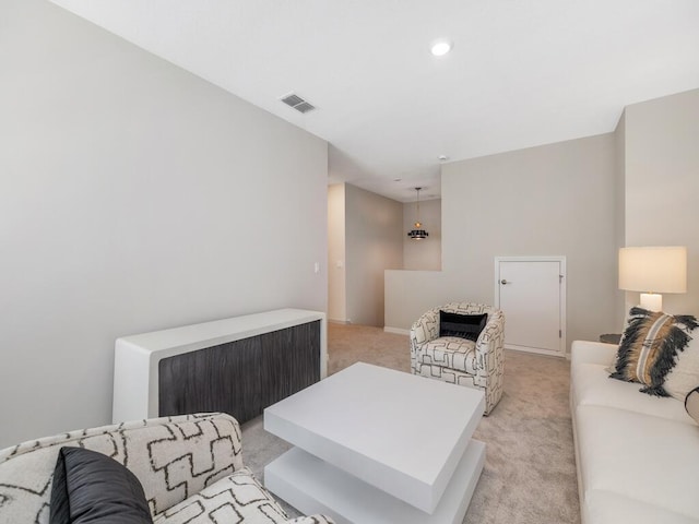 living area featuring light colored carpet and visible vents