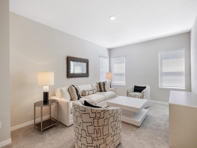 living room featuring baseboards and light carpet