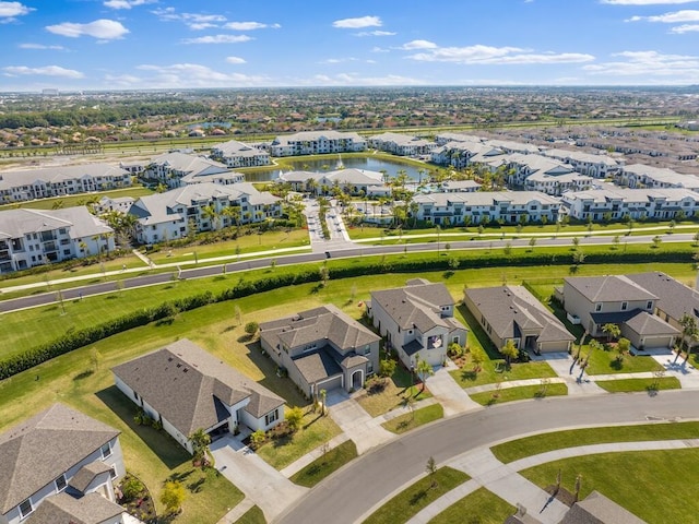 bird's eye view featuring a residential view and a water view