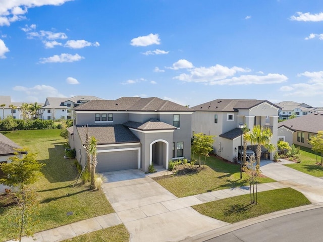 mediterranean / spanish house with a residential view, stucco siding, concrete driveway, and a front lawn