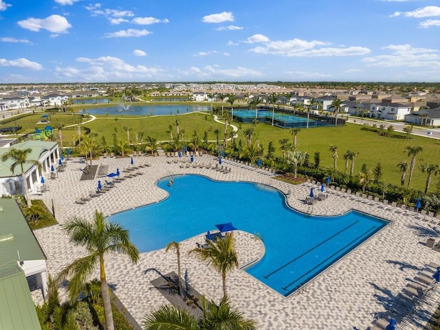 pool featuring a patio area and a water view