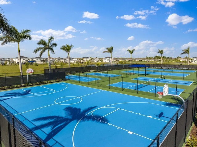 view of basketball court with community basketball court, fence, and a tennis court