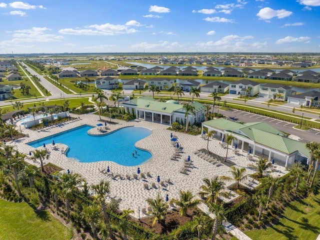 community pool with a residential view, a patio, and fence