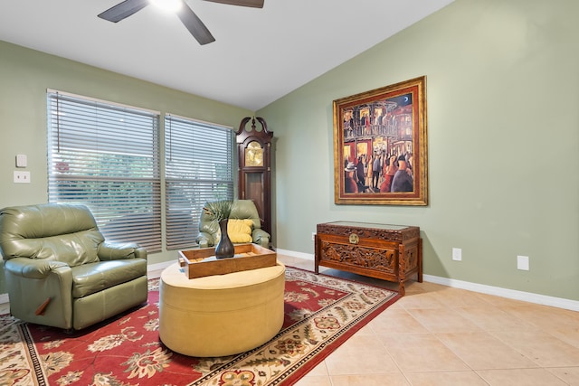 sitting room featuring light tile patterned floors, ceiling fan, baseboards, and lofted ceiling