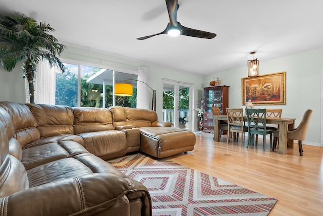 living area with french doors, a ceiling fan, light wood-type flooring, and a wealth of natural light