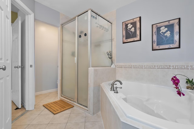 bathroom featuring tile patterned floors, a garden tub, and a shower stall