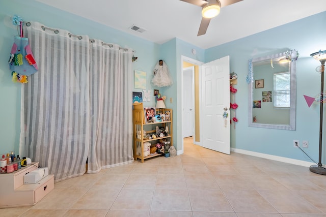 game room featuring tile patterned flooring, baseboards, visible vents, and ceiling fan