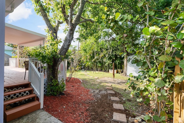 view of yard with a storage unit, an outdoor structure, and a deck