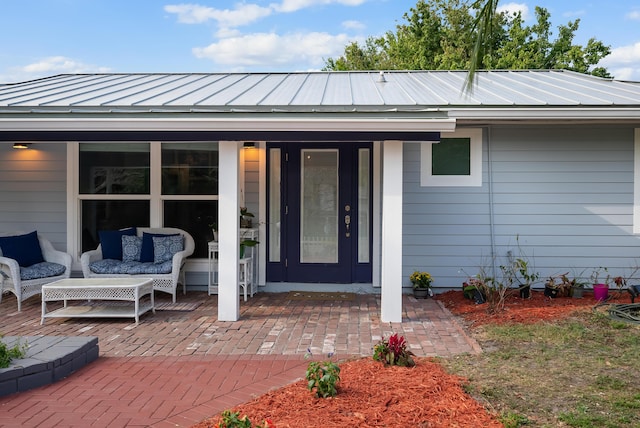 property entrance featuring metal roof and a standing seam roof