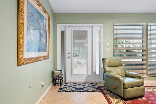 living area featuring baseboards and tile patterned flooring