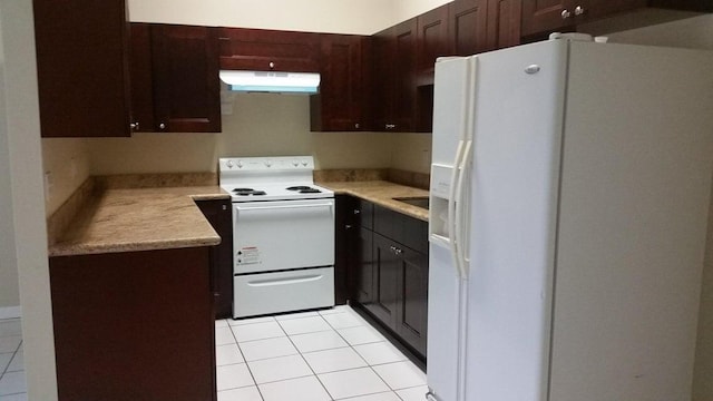 kitchen with under cabinet range hood, white appliances, dark brown cabinetry, light countertops, and light tile patterned floors