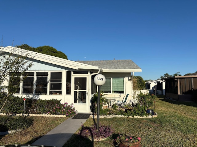 bungalow-style home featuring stucco siding, a patio, and a front lawn