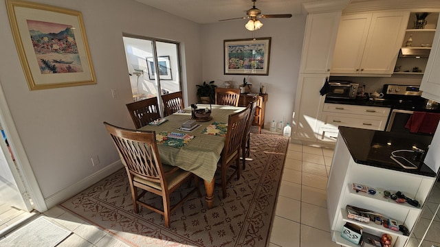 dining space with light tile patterned floors, baseboards, and ceiling fan