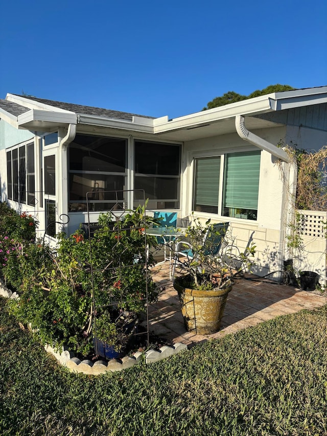 view of home's exterior featuring a sunroom