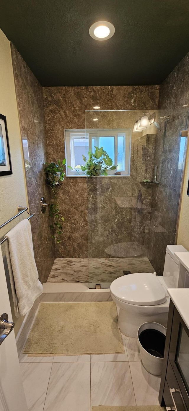 full bathroom with marble finish floor, a walk in shower, toilet, and a textured ceiling