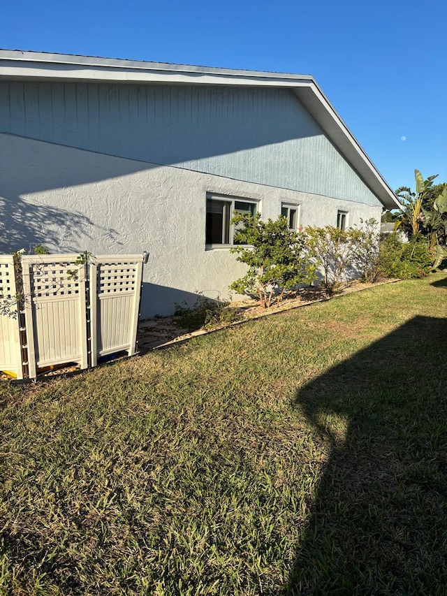 view of side of home featuring a yard