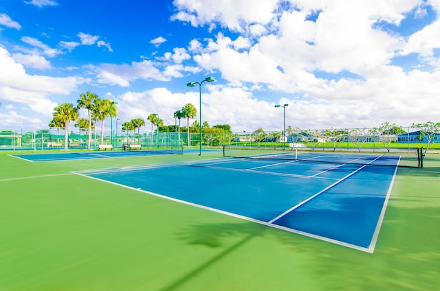 view of tennis court featuring fence