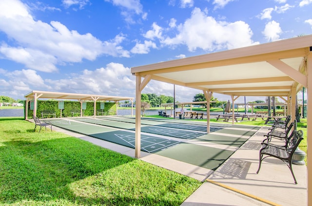 view of property's community with a yard and shuffleboard